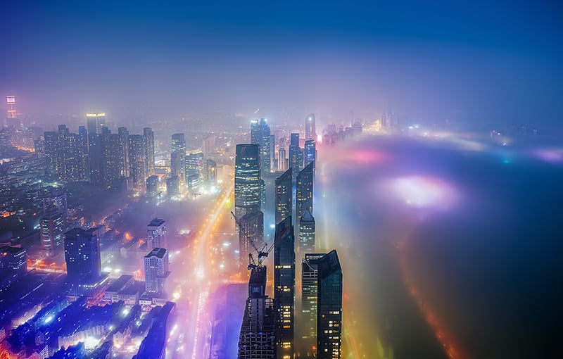 Lit up skyscrapers on beachfront at night